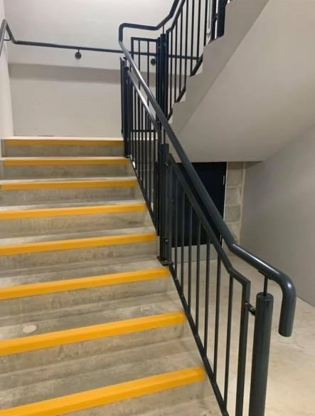 A black powered coated handrail