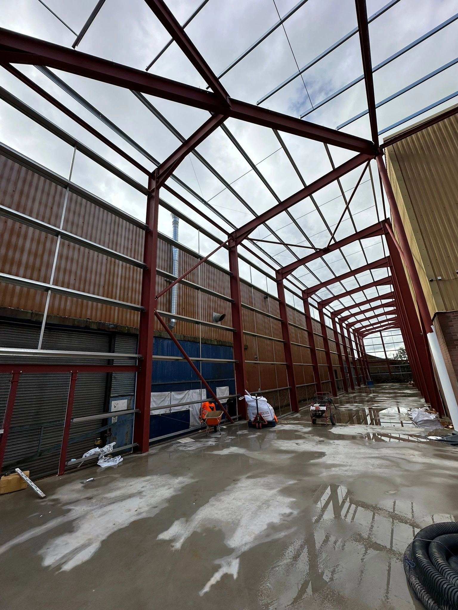 showing a last final cleanup before the building takes on its final roof and side panelling.