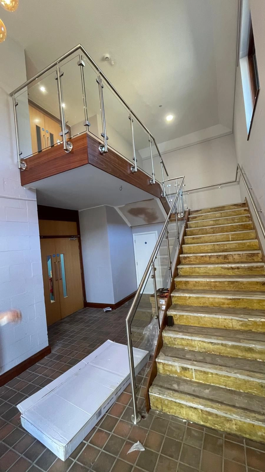 A picture showing our stainless steel balustrades on the upper floor and the same glass and stainless going towards the ground floor.