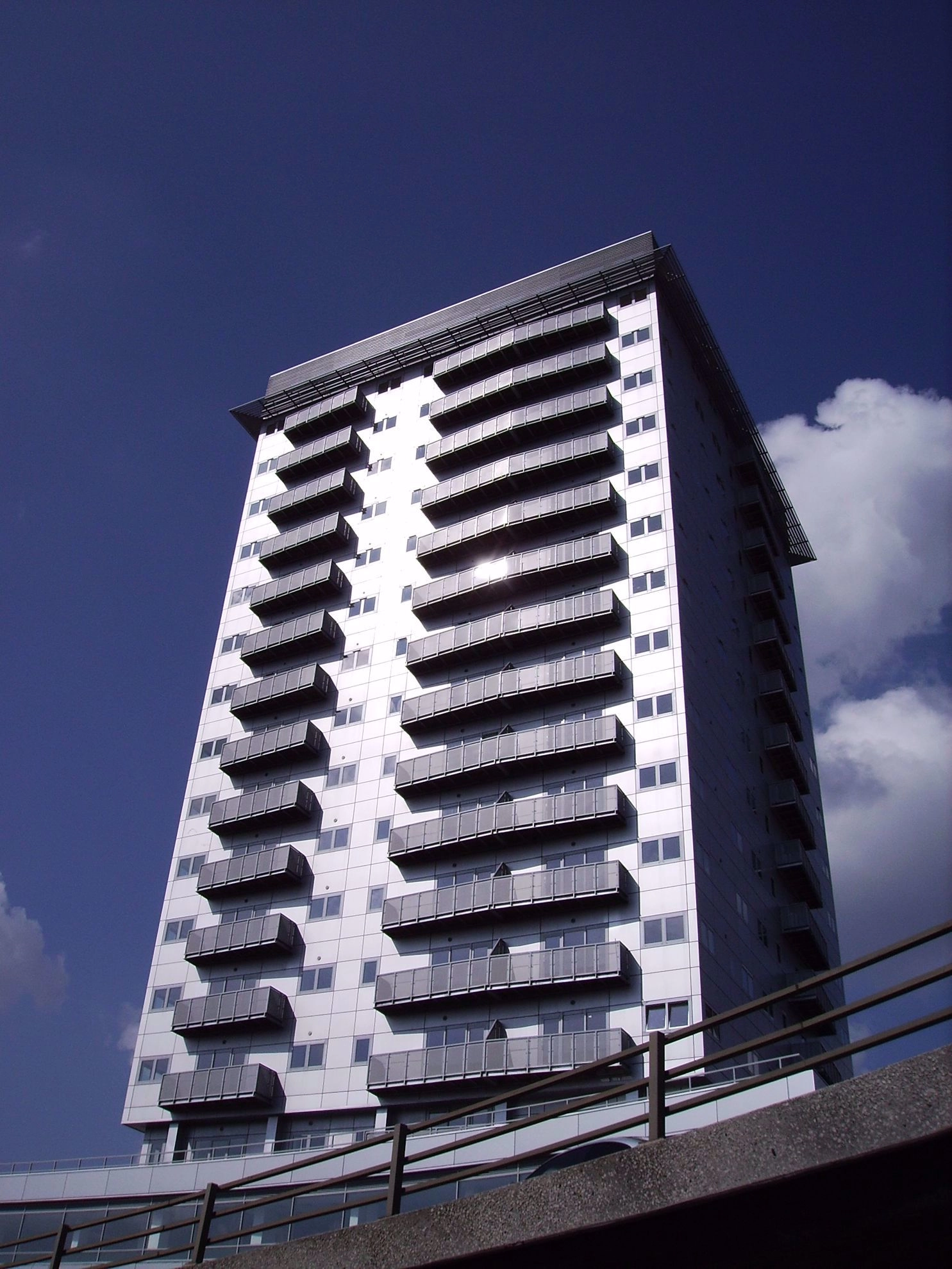 High-rise building showing each floor with a Juliet balcony