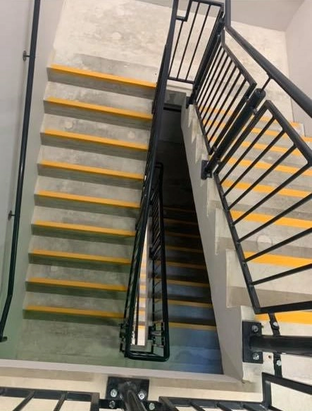 A black powered coated multi floor handrail