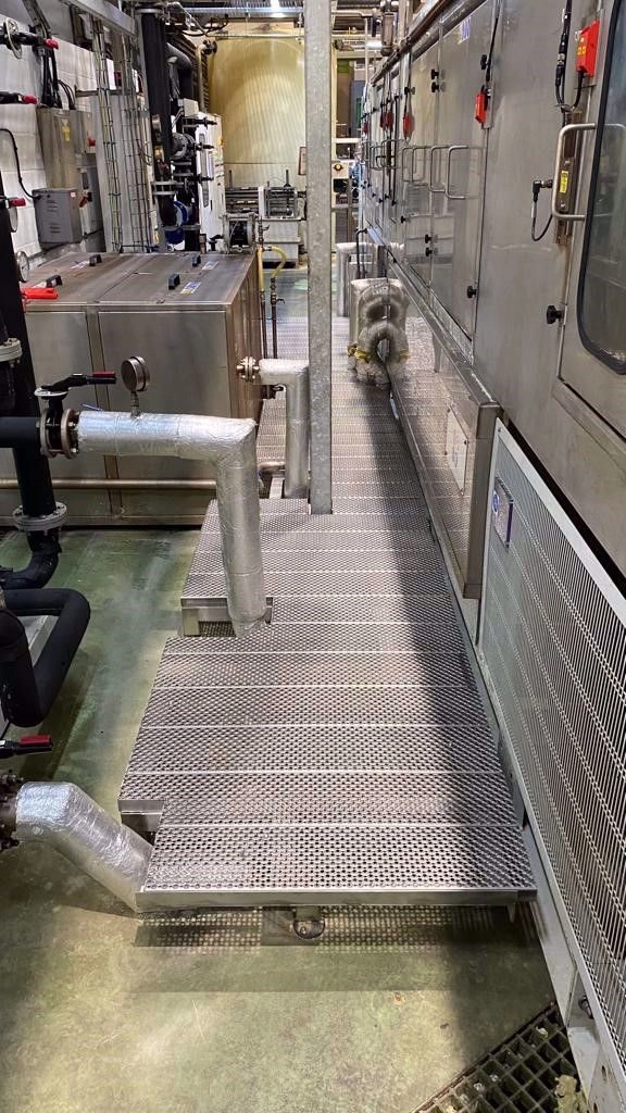 Bespoke platform walkway designed around industrial pipework