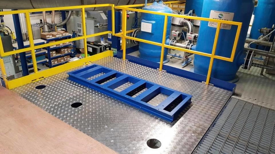 Stainless steel service platform with yellow guard handrail