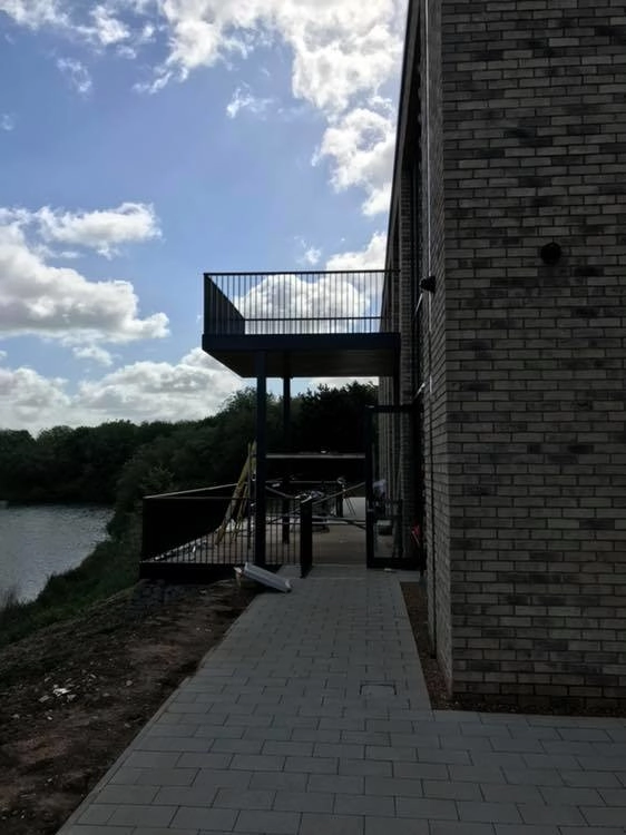 Steel fabricated balcony attached to the side of a building