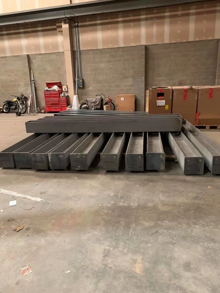 wide-flange beams sit in the work shop ready to be picked up and delivered out to site.