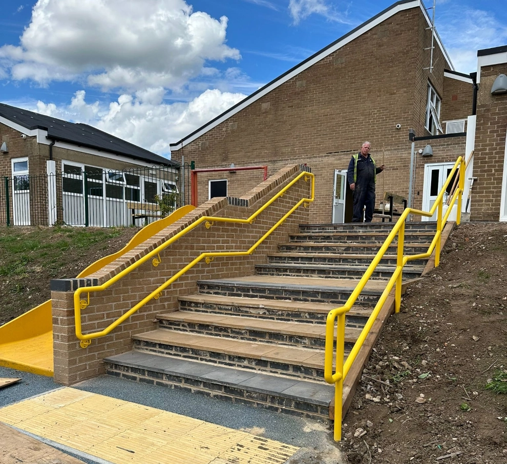 yellow hand rails, powered coated and installed on site.
